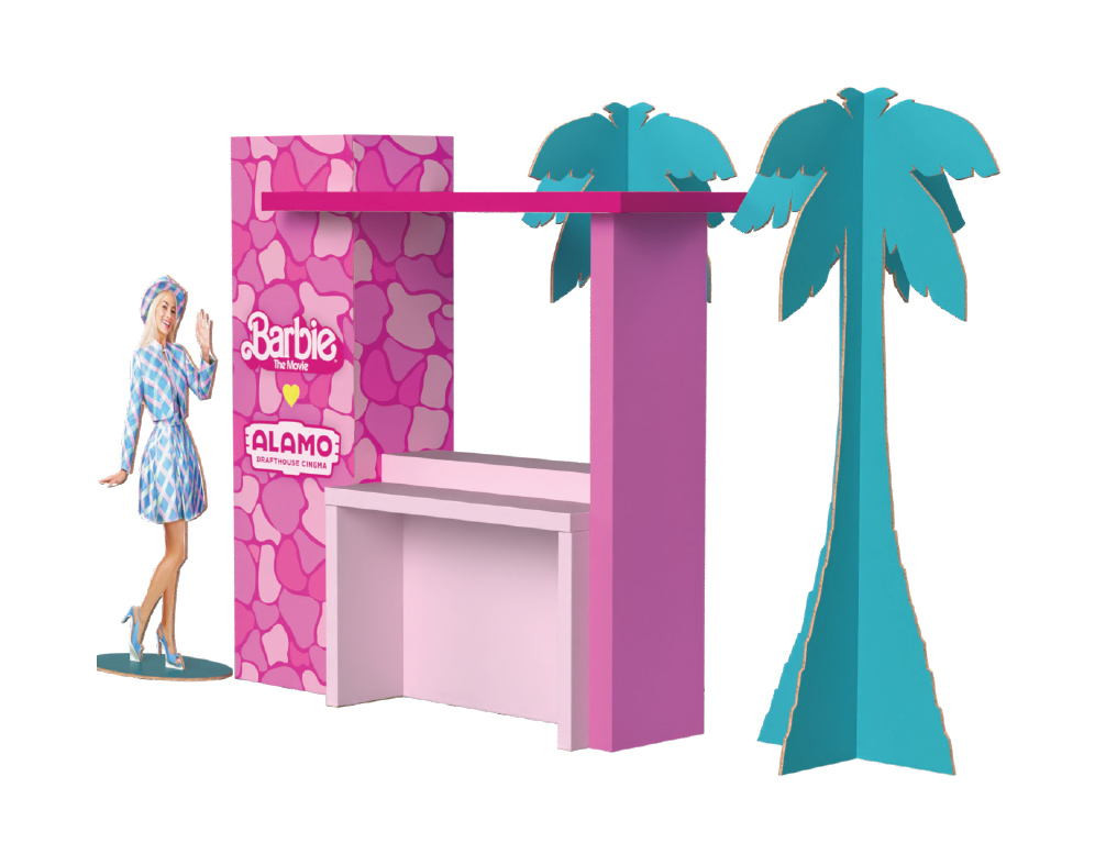 Barbie The Movie themed cardboard display stand with palm trees and a Barbie cutout, branded for Alamo Drafthouse Cinema