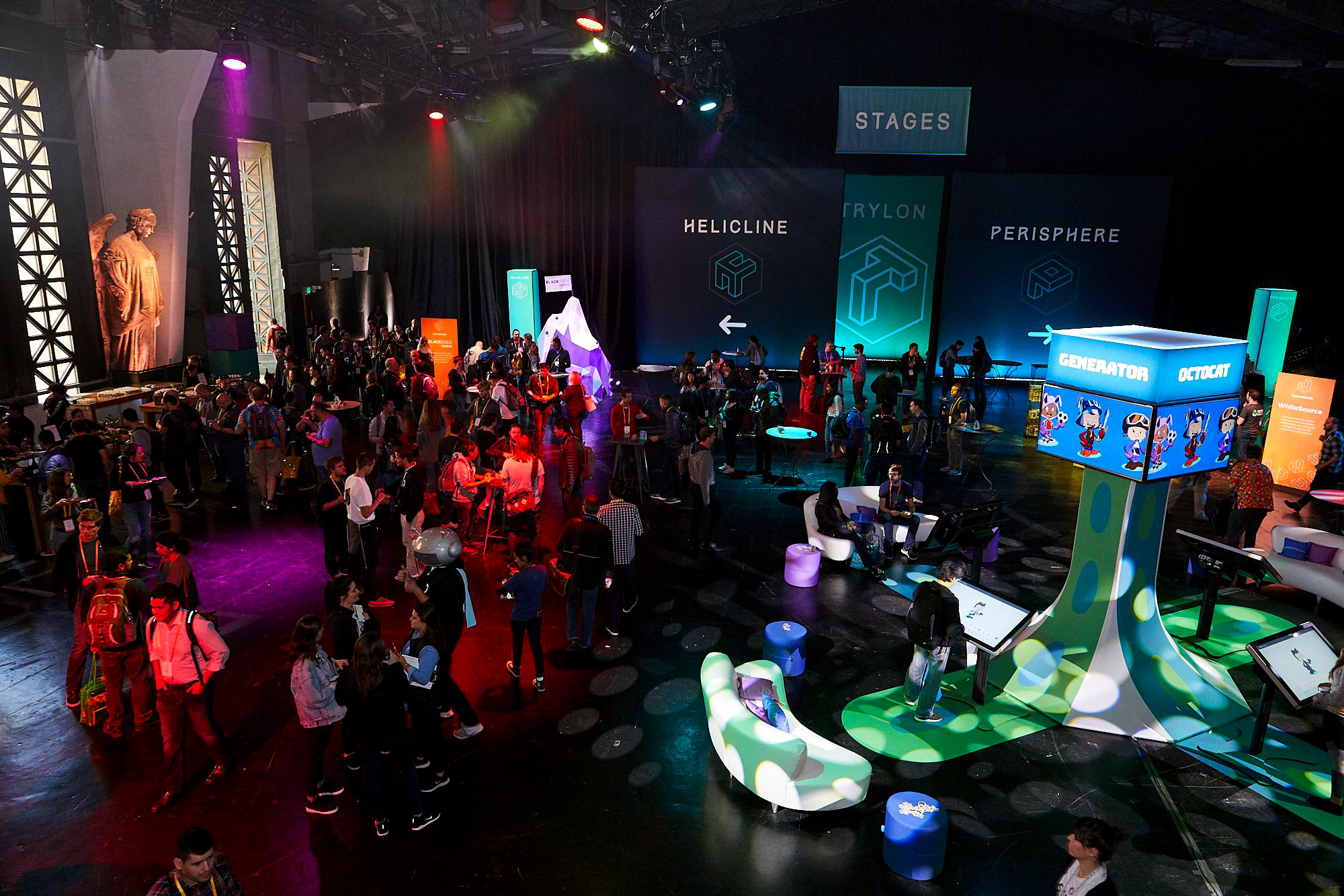 Large-scale immersive event environment with crowds of attendees, dramatic stage lighting, oversized character displays, and branded area signage including Helicline, Perylon, Perisphere, Generator, and Actbot zones
